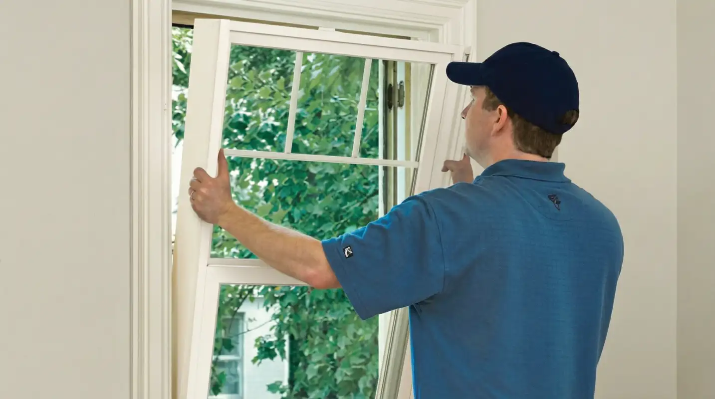 Professional contractors performing a residential window insulation and replacement service in Fargo, ND